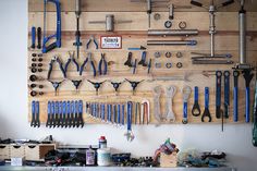 there are many tools hanging on the wall