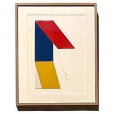 an abstract painting with red, blue, yellow and green shapes on white paper in a brown frame