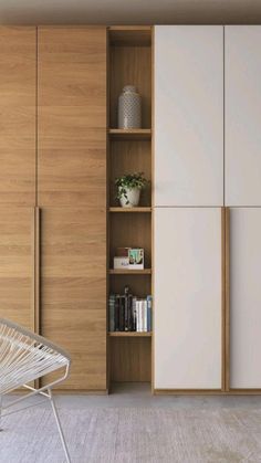 a white chair sitting in front of a wooden cabinet