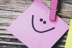 a piece of pink paper with a smiley face on it