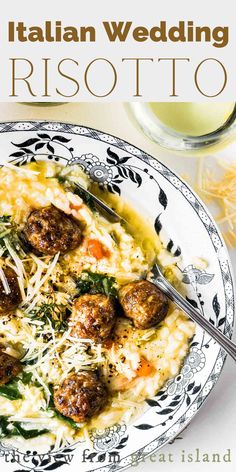 a white plate topped with meatballs covered in grated cheese next to a glass of wine