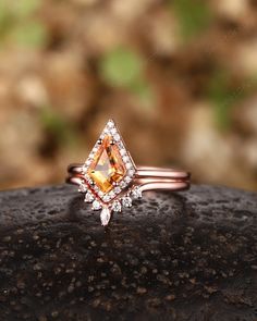 a diamond ring sitting on top of a rock