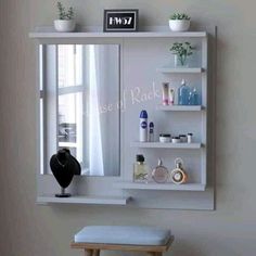 a white shelf with some bottles on top of it and a mirror in the middle