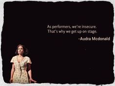 a woman standing in front of a black background with a quote from the book, as performers, we're insecure that's why we get up on stage