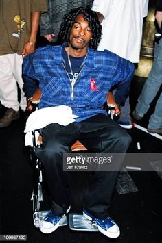 a man sitting in a wheel chair at an event