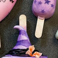 some fake witches are sitting on top of ice cream cones and popsicle stick holders