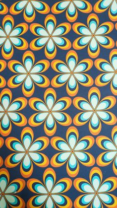 an orange, blue and yellow flower pattern on a black background with white circles in the center