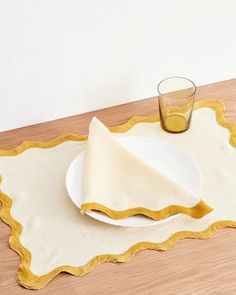 a white plate with a napkin and a glass on it