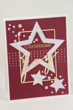 a red and white christmas card with stars