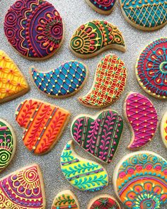 colorful decorated cookies are displayed on a counter top, including one with an intricate design