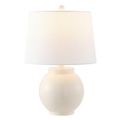 a white table lamp with a white shade on the base and a light bulb attached to it