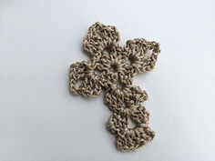 a crocheted cross on a white surface