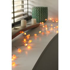 some white candles are sitting on a table