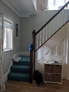 there is a blue carpeted stair case next to the stairs in this house,