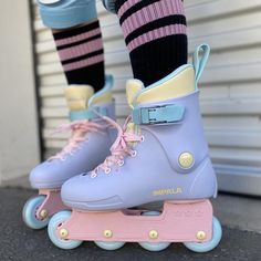 a person riding roller skates with pink and blue wheels