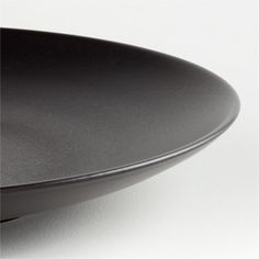 a black plate sitting on top of a white table