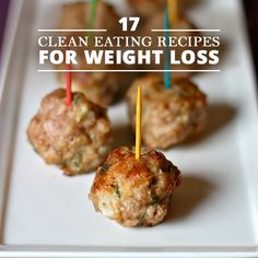 small meatballs with toothpicks on a white plate