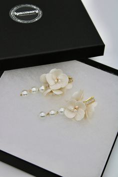 Gorgeous floral earrings with a romantic shape, style and handcrafted clay floral details. Finished with soft pearl trio drop which add a beautiful dangle.  A unique work of art.✨ DETAILS: > Designed and handcrafted in the UK Worldwide shipping > Made with clay flowers, pearls, cubic zirconia lever backs  > Handcrafted from tarnish resistant jewellery wire > Length: 6.5 cm (2.5") > Finish: silver or gold Thank you for visiting and please don't hesitate to contact us when a question comes up. --- Pearl Drop Flower Earrings For Wedding, Delicate Pearl Charm Flower Earrings For Wedding, Pearl Earrings With Flower Charm For Wedding, Wedding Pearl Earrings With Flower Charm, Elegant Pearl Earrings With Flower Charm For Wedding, Elegant Handmade Flower Earrings, Pearl Flower Wedding Earrings, Elegant Bridal Flower Earrings With Handmade Flowers, Elegant Cream Flower Earrings For Gift