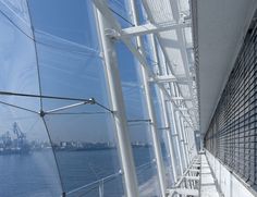 the railings on the side of a boat are clear and blue with ships in the background