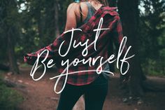 a woman walking in the woods with her back to the camera and text that says just be yourself