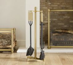 two black brooms are standing next to each other in front of a fireplace