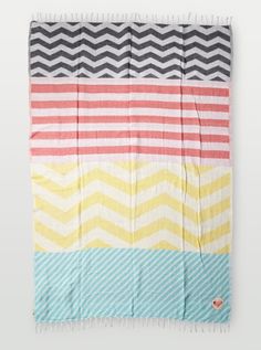 a multicolored blanket hanging on the wall