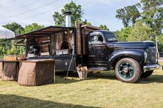 an old truck is parked in the grass