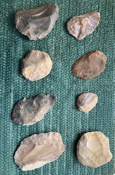 several rocks are arranged on a green surface