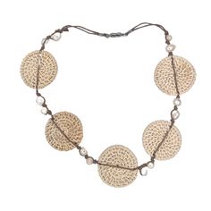 This lightweight statement necklace elegantly combines the luminous beauty of freshwater pearls with the earthy beauty of hand woven rattan. A double strand of waxed cotton knots 12 pearls in place. A piece of organic luxury that will elevate any ensemble. The magnetic closure makes it a snap to put on and remove. The rattan circles are about 1.75". The length of the necklace open is 21". If you would like a shorter version, just leave a note. Add this to your vacation wardrobe today! Adjustable Multi-strand Hand Wrapped Necklace, Elegant Woven Jewelry For Vacation, Elegant Round Natural Jewelry, Handwoven Necklace For Beach, Elegant Natural Round Jewelry, Artisan Adjustable Natural Necklace, Artisan Adjustable Natural Necklaces, Artisan Adjustable Natural Color Necklaces, Adjustable Multi-strand Shell Necklace For Beach