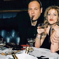 two people sitting at a table with wine glasses