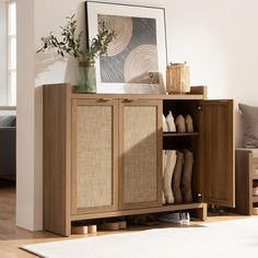 a wooden cabinet with some shoes in it and a vase on the shelf next to it