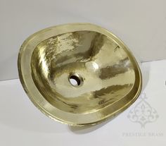 a gold sink is shown on a white surface