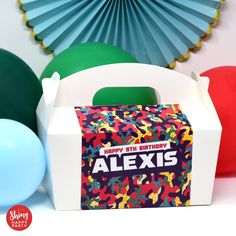 a birthday party with colorful balloons, paper fans and personalized gift box for alex's