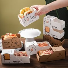 a person is grabbing some food out of boxes