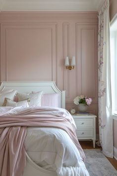 a bedroom with pink walls and white furniture