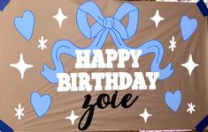 a happy birthday sign with blue bows and hearts