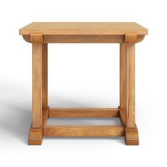 a small wooden table sitting on top of a white floor