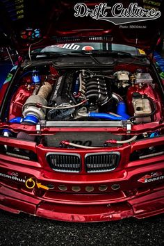 the engine compartment of a red sports car