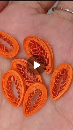 five orange plastic circles in the palm of someone's hand