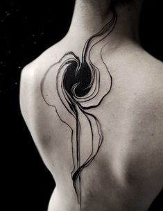 a woman's back with a tattoo on it