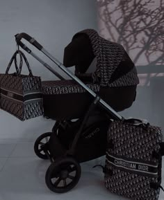 a black and white baby stroller with two bags