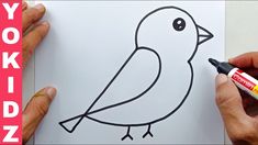 someone is drawing a bird on paper with crayons