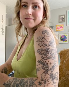 a woman with tattoos on her arm posing for the camera