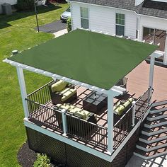 an overhead view of a house with a deck and covered patio area in the backyard