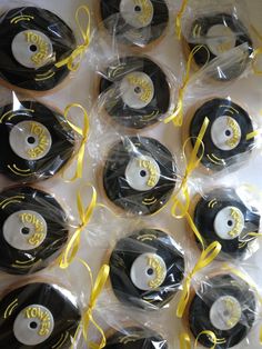 twelve black and white discs with yellow ribbons