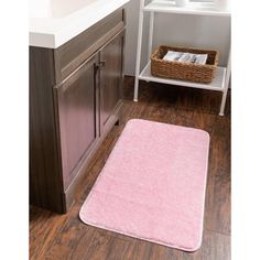 a bathroom with a pink rug on the floor