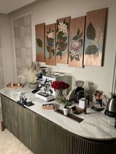 a kitchen counter topped with lots of pots and pans filled with flowers on top of it