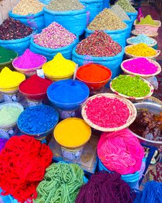 many bowls filled with different colored food items