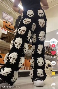 a woman in black and white pants with skulls on them