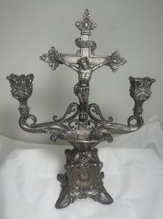 an ornate silver candelabra with four candle holders on it's sides